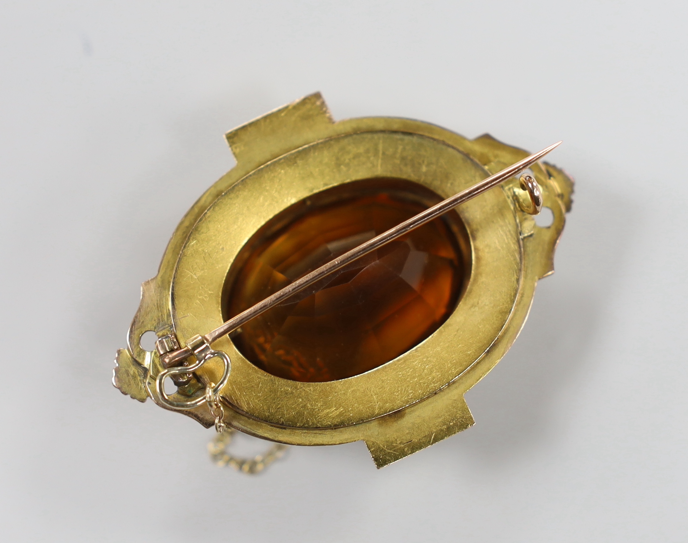 A Victorian yellow metal and large oval cut citrine set brooch, with split pearl set border, 51mm, gross weight 26.6 grams.